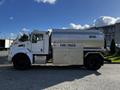 A 2013 Kenworth T370 fuel truck with a silver tank and the words FUEL TRUCK and DIESEL printed on the sides