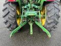A 2003 John Deere 790 tractor showing the rear view with large tires and three-point hitch attachments