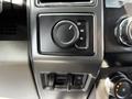 A control panel featuring a four-wheel drive selector knob and vents in a 2021 Ford F-550