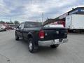 A black 2010 Dodge Ram pickup truck viewed from the back with a truck bed and visible license plate on the rear