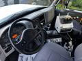 Interior view of a 2011 International 7300 showing the driver's seat dashboard controls and equipment layout including gauges levers and a control panel