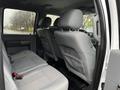 Interior view of a 2014 Ford F-550 showing the back seat area with gray upholstery and headrests