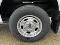 Close-up of a wheel and tire from a 2011 Ford F-250 SD showing a silver alloy rim with a Ford logo and a black tire tread