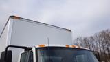 A 2012 International TerraStar truck with a boxy cargo area and multiple orange lights on the roof