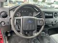 Interior view of a 2011 Ford F-250 SD showing the steering wheel and dashboard with control dials and a multimedia display