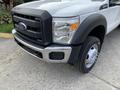 A 2012 Ford F-550 with a distinctive black grille and chrome accents showcasing its Super Duty branding and a single wheel on the front passenger side