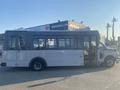 A 2017 Chevrolet Express bus with a white exterior and large windows on the side, designed for passenger transport