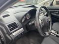 Interior view of a 2014 Subaru Impreza showcasing the dashboard steering wheel and instrument cluster