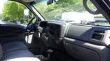 Interior view of a 2006 Ford F-650 showing the dashboard steering wheel and gear shift with a fabric seat