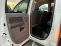 Interior view of a 2008 Dodge Ram 5500 showing the driver side door open with a glimpse of the front and rear seats