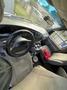 Interior of a 2002 Ford Econoline with a steering wheel center console and gray upholstery