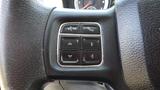 Close-up of a steering wheel control panel featuring buttons for voice recognition phone call answering and directional navigation