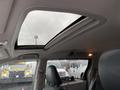 Interior view of a 2013 Toyota Sienna featuring a large sunroof and a black front seat