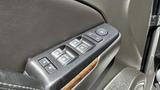 Close-up of the driver side door control panel of a 2018 Chevrolet Tahoe featuring window controls and lock buttons