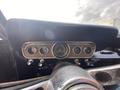 Dashboard of a 1966 Ford Mustang featuring vintage gauges knobs and a classic design