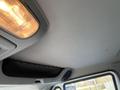 Interior view of a 2013 International 4300 showing the ceiling light and overhead storage area with a mesh cover