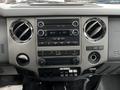 Dashboard of a 2014 Ford F-550 featuring audio controls air vents and various buttons for vehicle functionality