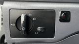 A control panel featuring various switches and dials for lights and fog lights in a 2012 Ford Transit vehicle