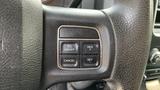 Close-up of the steering wheel controls of a 2013 RAM 2500 featuring buttons for on/off cancel resume and set functions