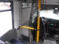 Interior view of a 2016 Chevrolet Express showing a driver's seat dashboard and control panel with a yellow safety bar in front