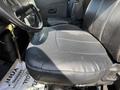 The driver seat of a 2009 International 7500 truck featuring black leather upholstery with visible stitching and a slight wear pattern