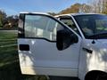 A 2008 Ford F-150 XL with the driver's door open revealing the interior and side mirror