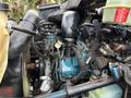 Close-up of a 2007 International 4200 engine showcasing blue components wires and hoses