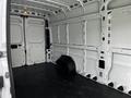 Interior of a 2019 RAM Promaster cargo van with empty white walls and a black tire lying on the floor