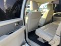 Interior view of a 2013 Ford Expedition showing beige leather seats and door panel