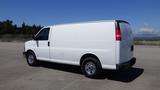 A white 2012 GMC Savana van parked with a simple cargo design featuring sliding side door and chrome wheels