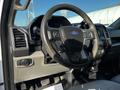 A 2017 Ford F-150 interior showcasing the steering wheel and dashboard with controls and a display