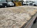 A wooden flatbed of a 2007 International 4300 truck showing weathered and worn surfaces with visible markings and imperfections