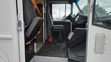 Interior view of a 2006 Ford Econoline showing two seats and the driver's area with controls visible