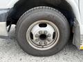A close-up view of a 2015 Chevrolet Express wheel showcasing a silver steel rim and a black tire with visible tread pattern