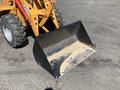 A yellow 2024 Traner TR 45 front loader bucket with a wide, curved edge and visible dirt inside