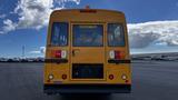 2014 Freightliner Thomas Bus Diesel with a bright yellow exterior and visible emergency door sign at the rear