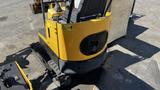 A yellow 2021 Cael-1T Mini with a compact design featuring a textured seat and safety decals on the side