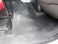 Interior floor of a 2015 International 4400 showing a rubber floor mat and a portion of the driver's seat area