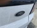 Close-up of the Land Rover emblem on the rear of a white 2020 Range Rover Sport