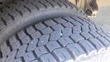 Close-up of a tire from a 2011 Ford Econoline showing tread pattern and surface details