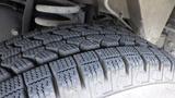 Close-up of a tire tread on a 2011 Ford Econoline showing detailed patterns and grooves designed for traction and grip