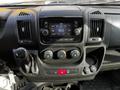 The dashboard of a 2019 RAM Promaster featuring a touchscreen display climate controls and gear shift lever