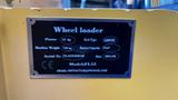 A metal plaque displaying specifications for a 2024 Fland FL45 wheel loader including power weight fuel type and serial number