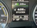 A car dashboard display showing mileage of 100488 km fuel range of 240 km outside temperature of 27.5 degrees Celsius and time set at 4:06 PM on July 12 2024