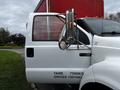 A 2008 Ford F-750 truck with an open driver's door displaying the vehicle's weight specifications on the side
