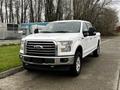 A white 2017 Ford F-150 pickup truck parked with a chrome grille and large tires