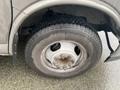 A close-up view of a tire mounted on a wheel of a 2017 Chevrolet Express showing the tread pattern and wheel rim design