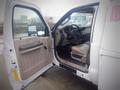 A 2008 Ford F-550 with an open door revealing a beige interior and dashboard with steering wheel and seat visible