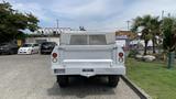 A white 2013 RAM 2500 pickup truck viewed from the rear with a metal mesh bed cover and red taillights