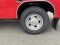 A close-up of a 2011 Ford F-250 SD wheel featuring a silver rim and a Firestone all-terrain tire with visible tread patterns